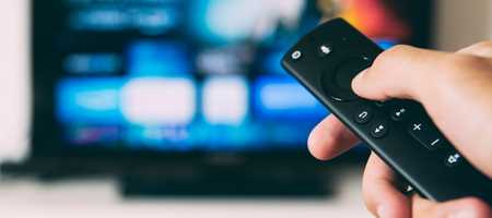 Blurred out Television with a TV remote in the fore front unblurred.